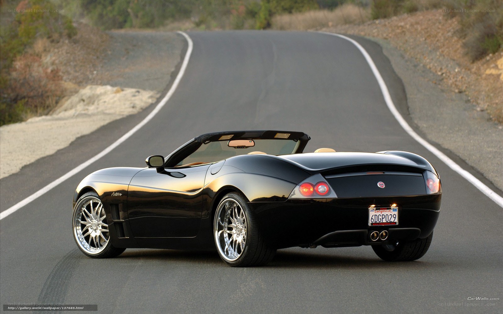 black convertible on winding road