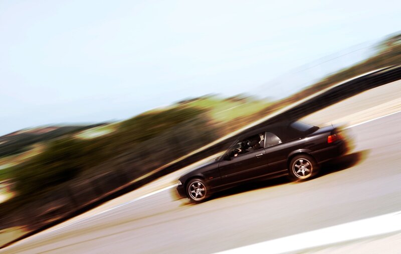 Black convertible speeding on track