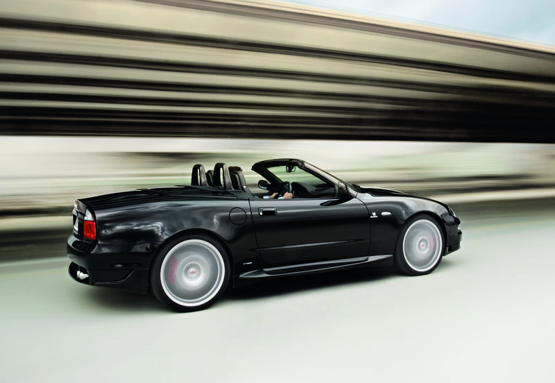 Black convertible sports car in motion