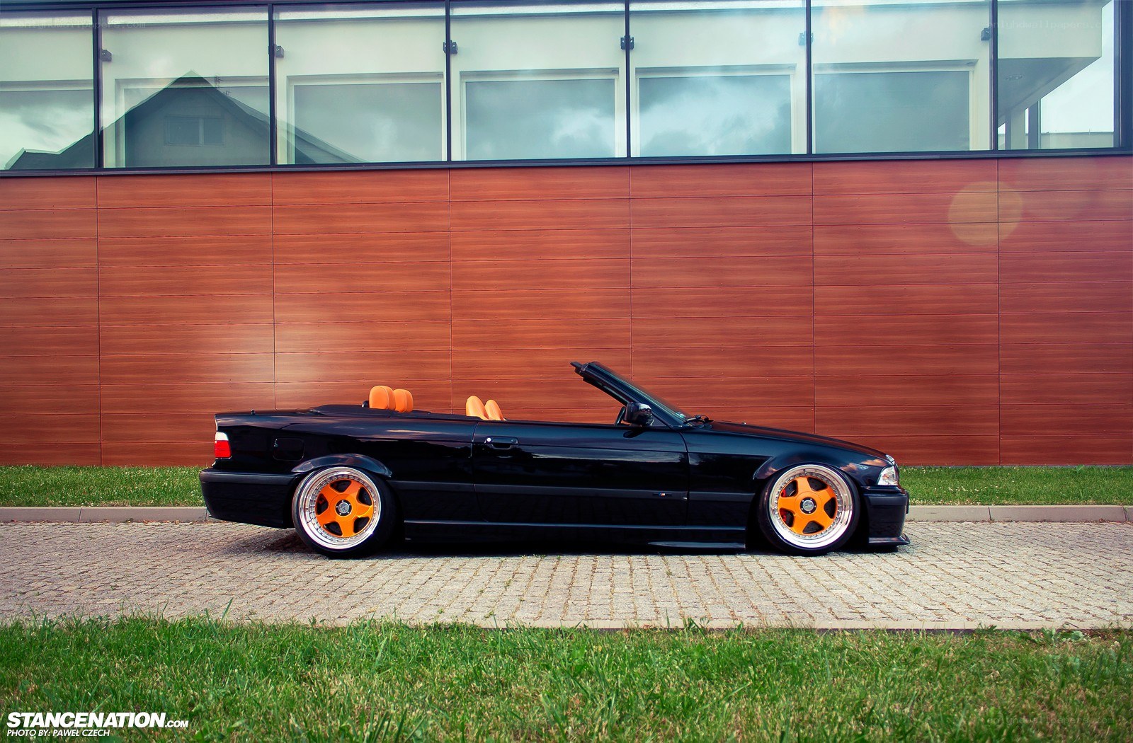 Black convertible with orange wheels