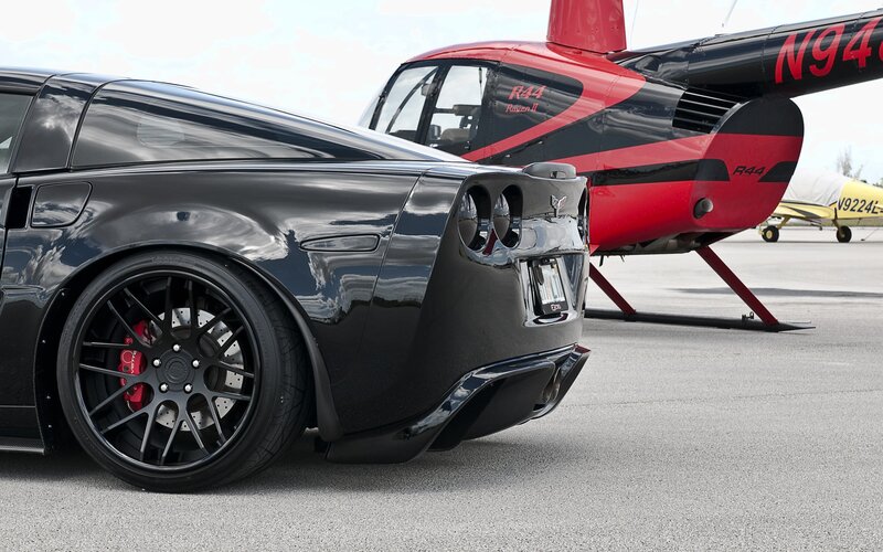 Black Corvette and helicopter
