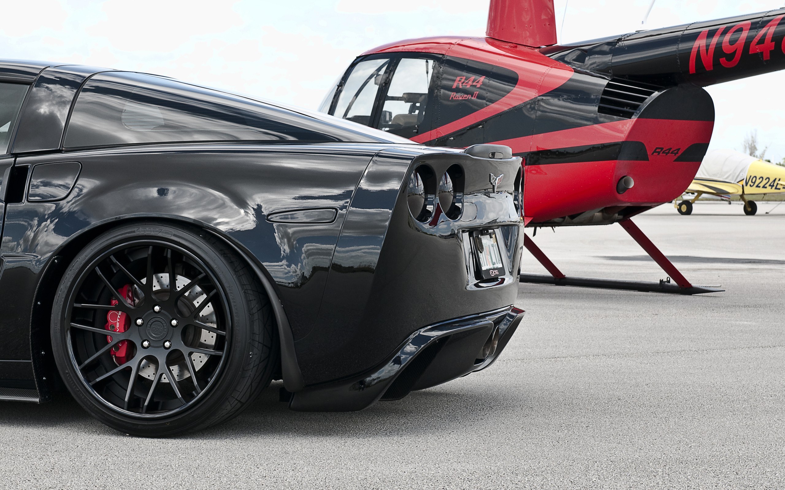 Black Corvette and helicopter