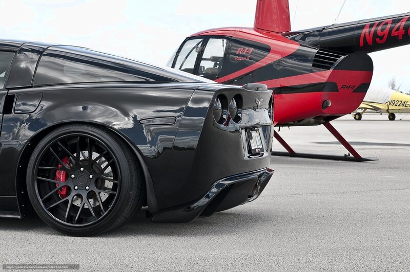 Black Corvette and helicopter