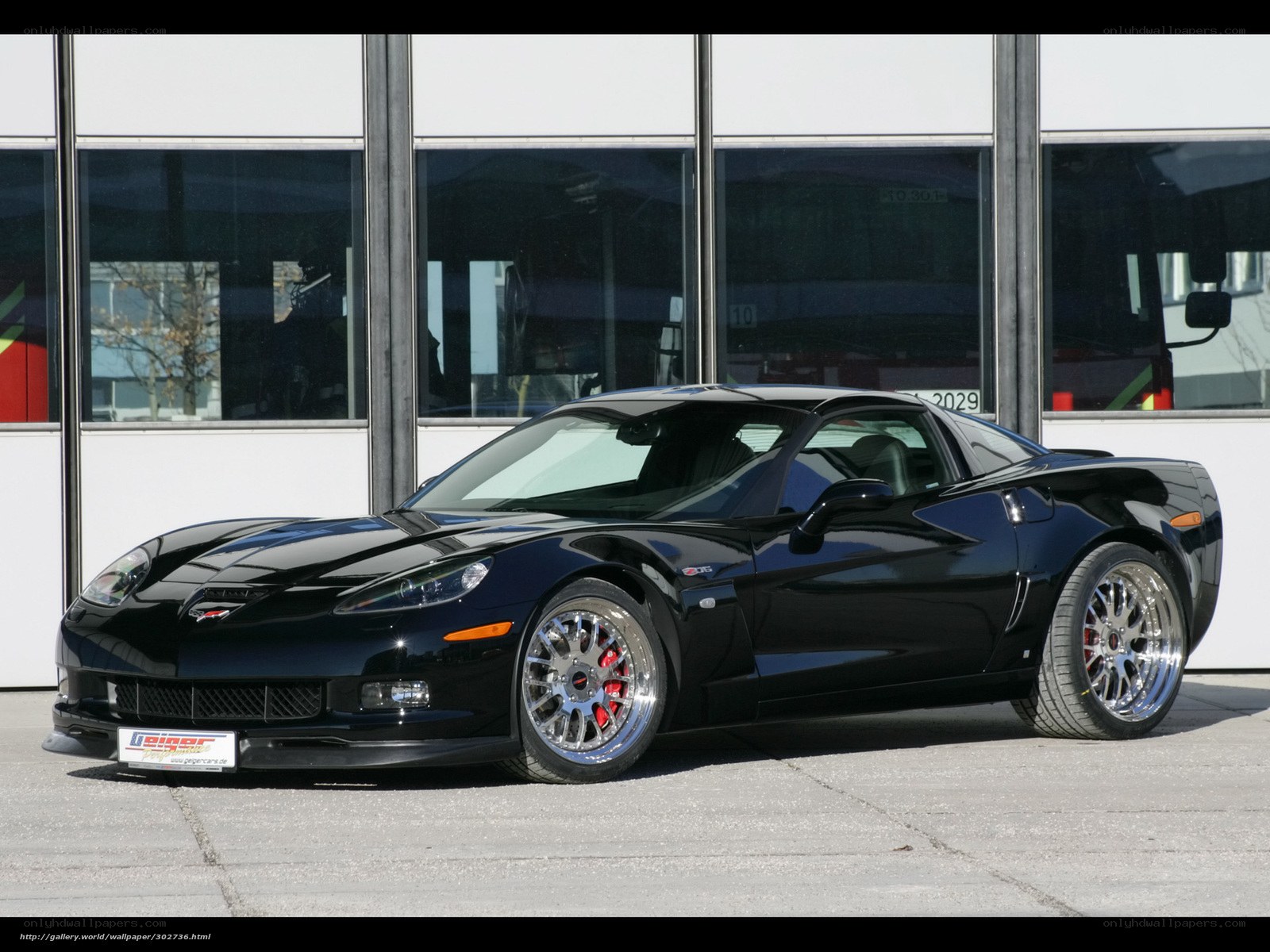 Black Corvette C6 in front of building