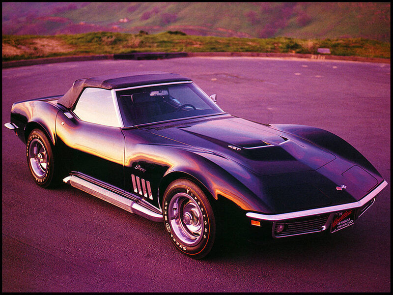 Black Corvette convertible on road