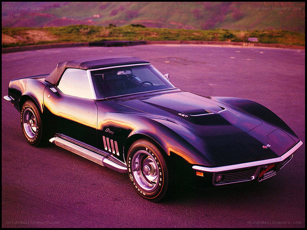 Black Corvette convertible on road