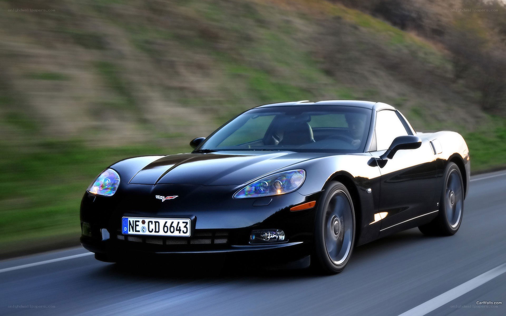 black corvette driving on road