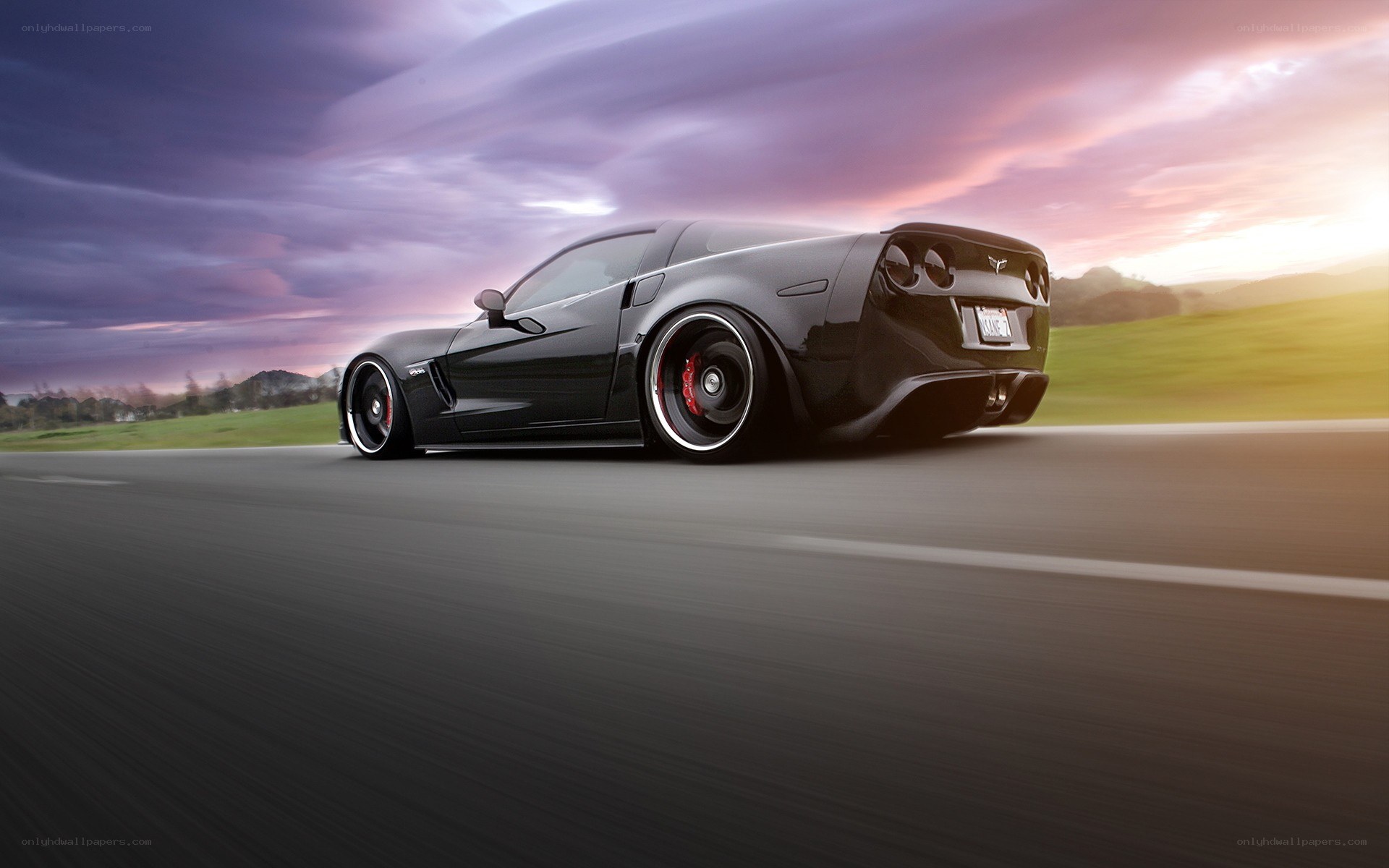 Black Corvette driving on road