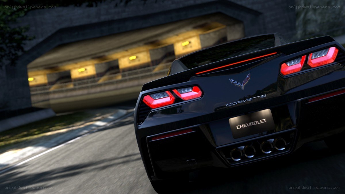 black corvette driving under tunnel