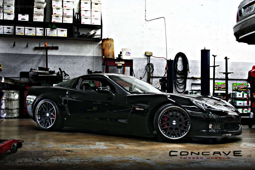 Black Corvette in a garage