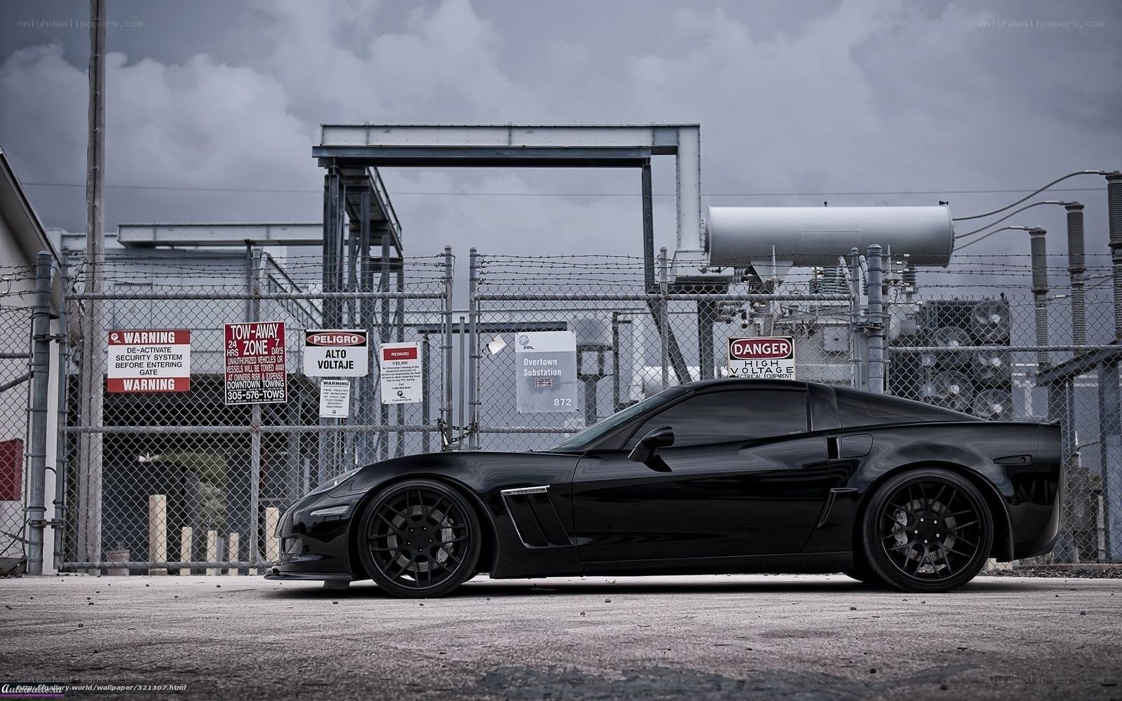 Black Corvette in industrial setting