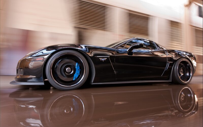 Black Corvette in motion