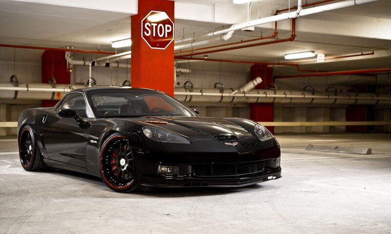 Black Corvette in parking garage