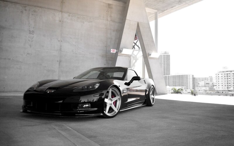 Black Corvette in urban garage