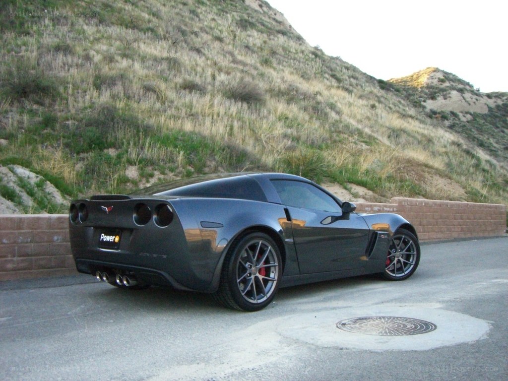 Black Corvette on a hillside road