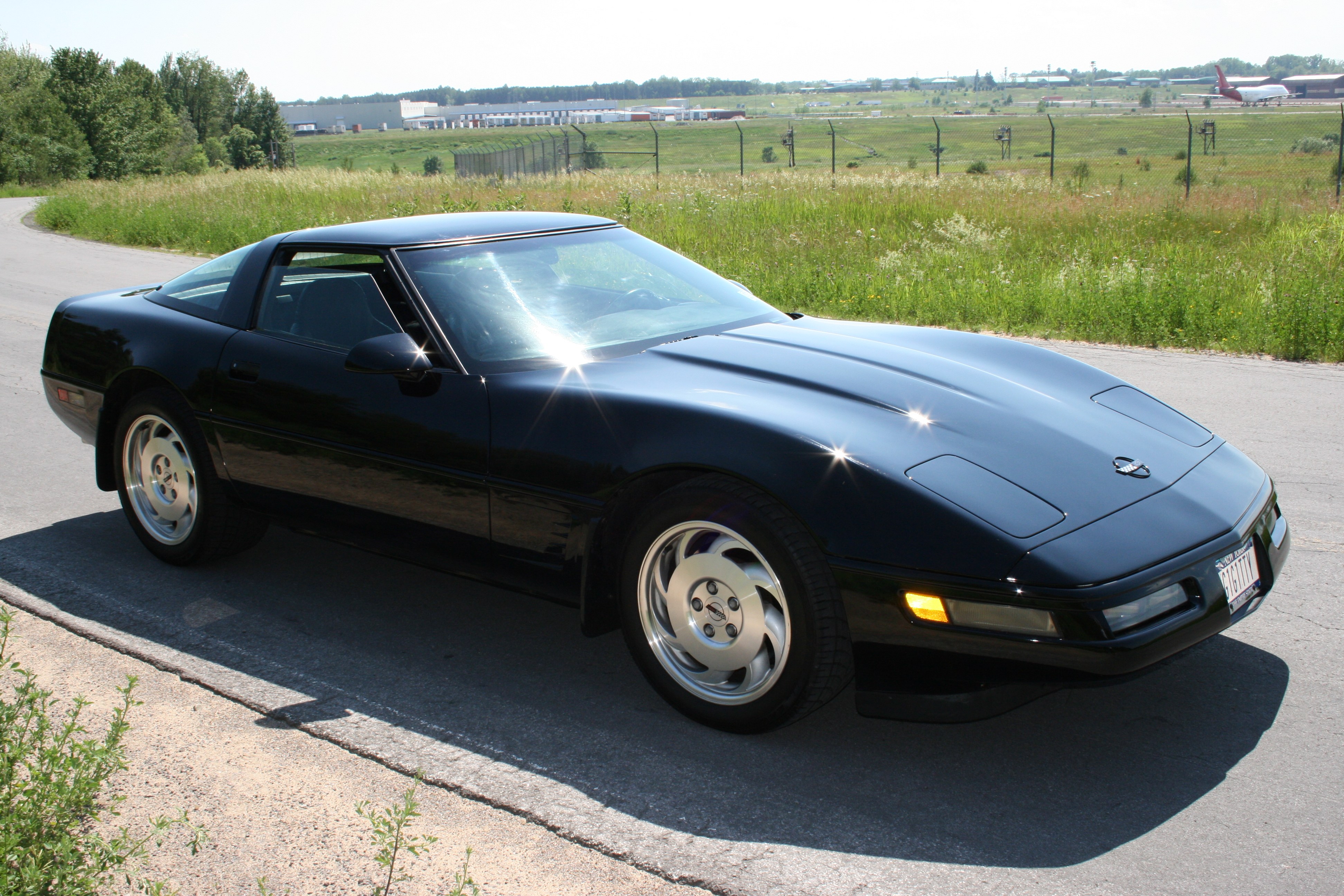 Black Corvette on a road