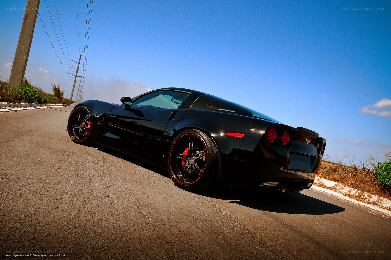 Black Corvette on a sunny road