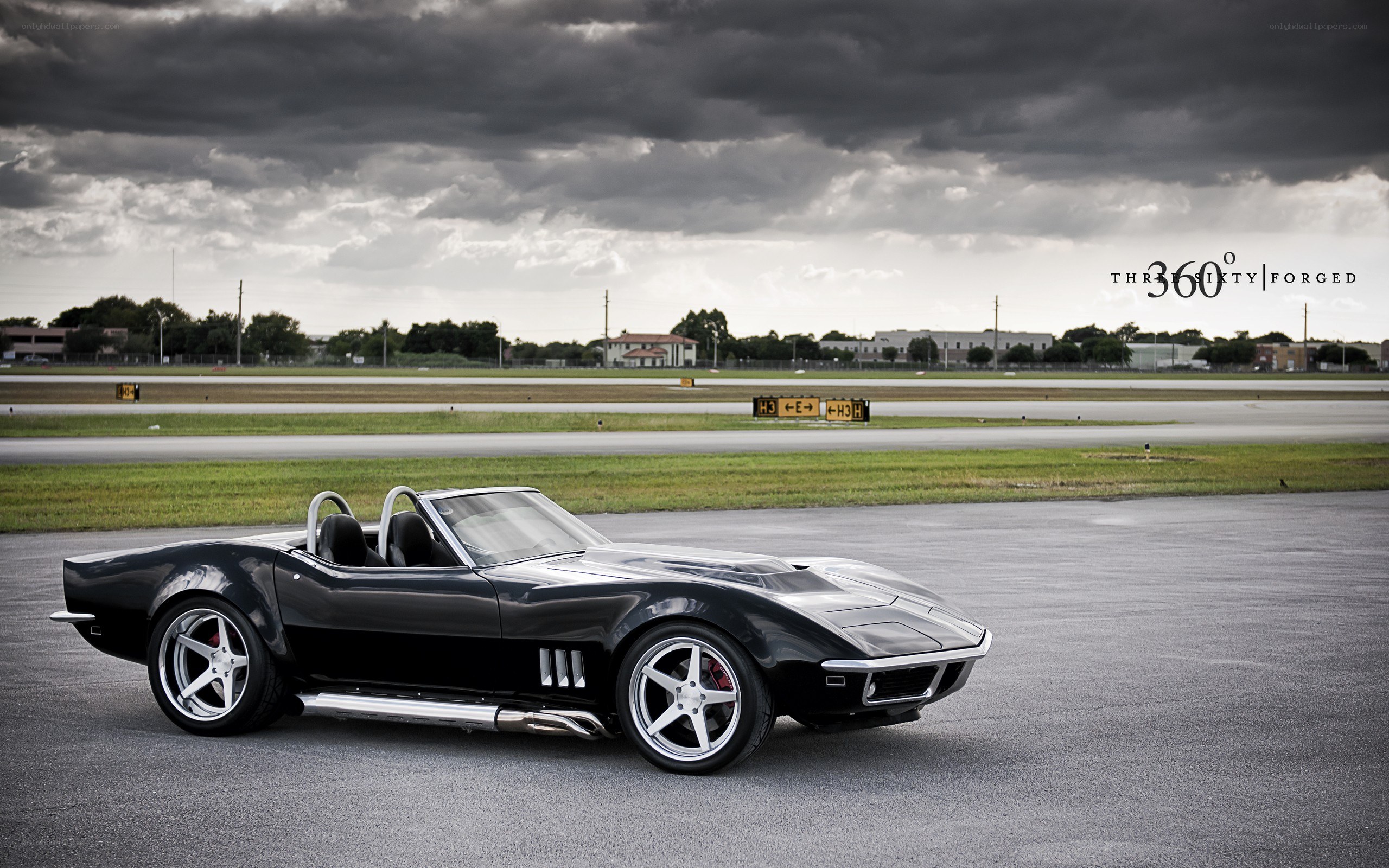 Black Corvette on a tarmac