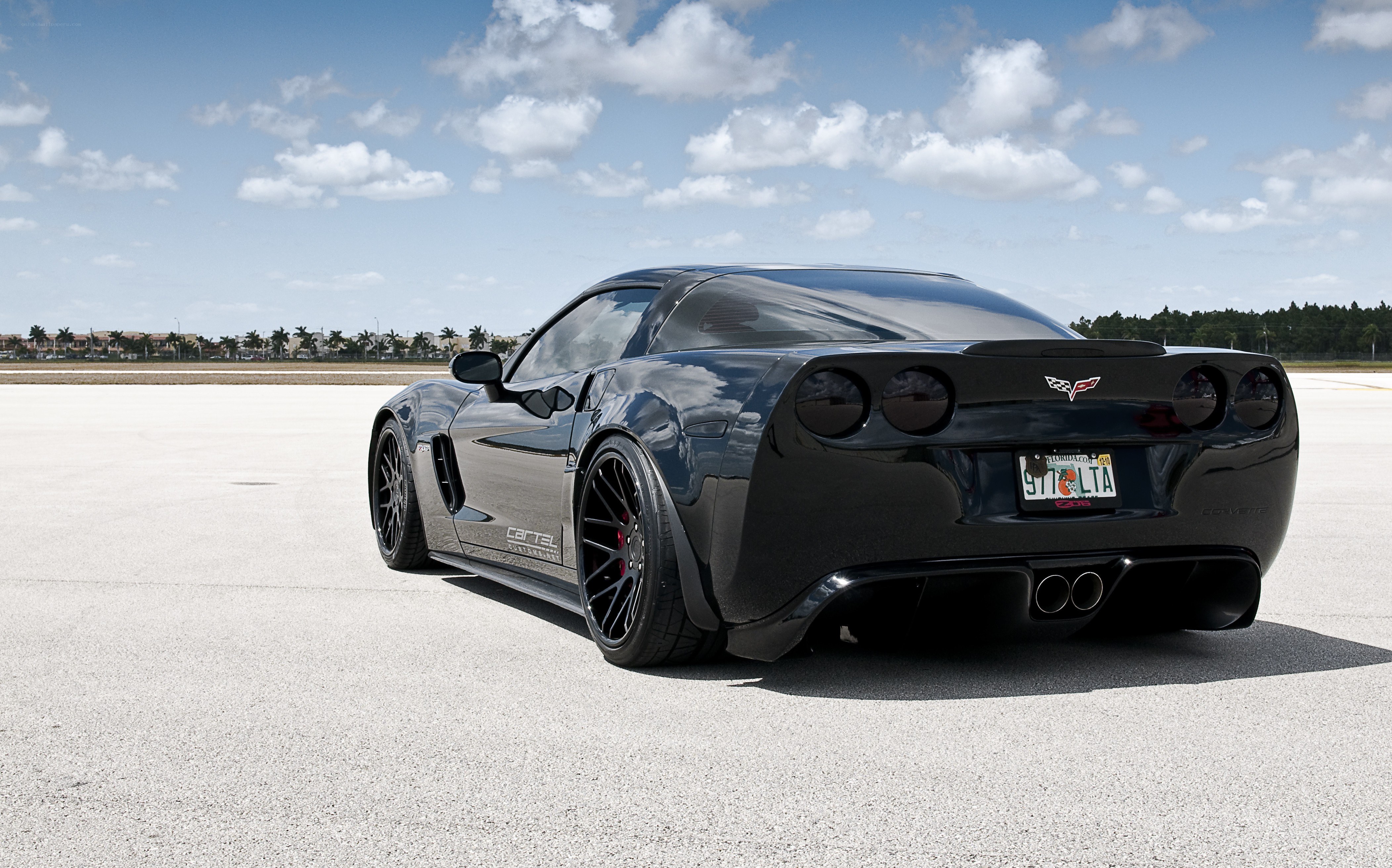 Black Corvette on a tarmac