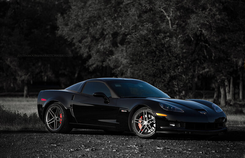 Black Corvette on gravel road