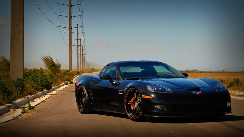 Black Corvette on Road — Dramatic