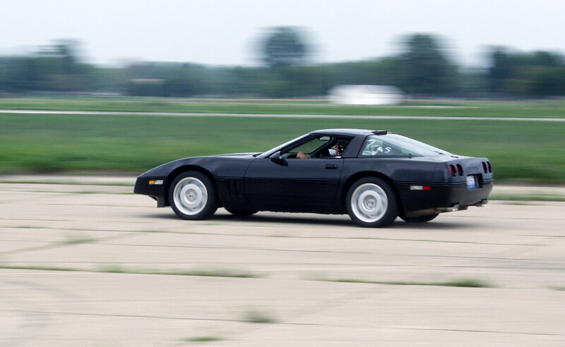 Black Corvette on Track — Dynamic