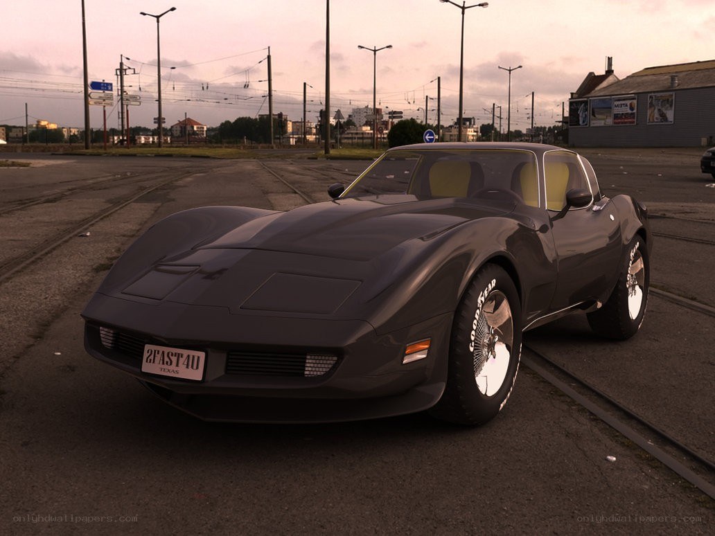 Black Corvette on train tracks