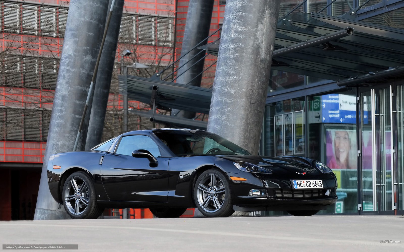 Black Corvette parked outside building