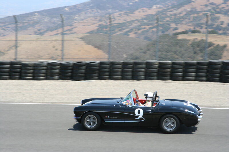 Black Corvette racing on track