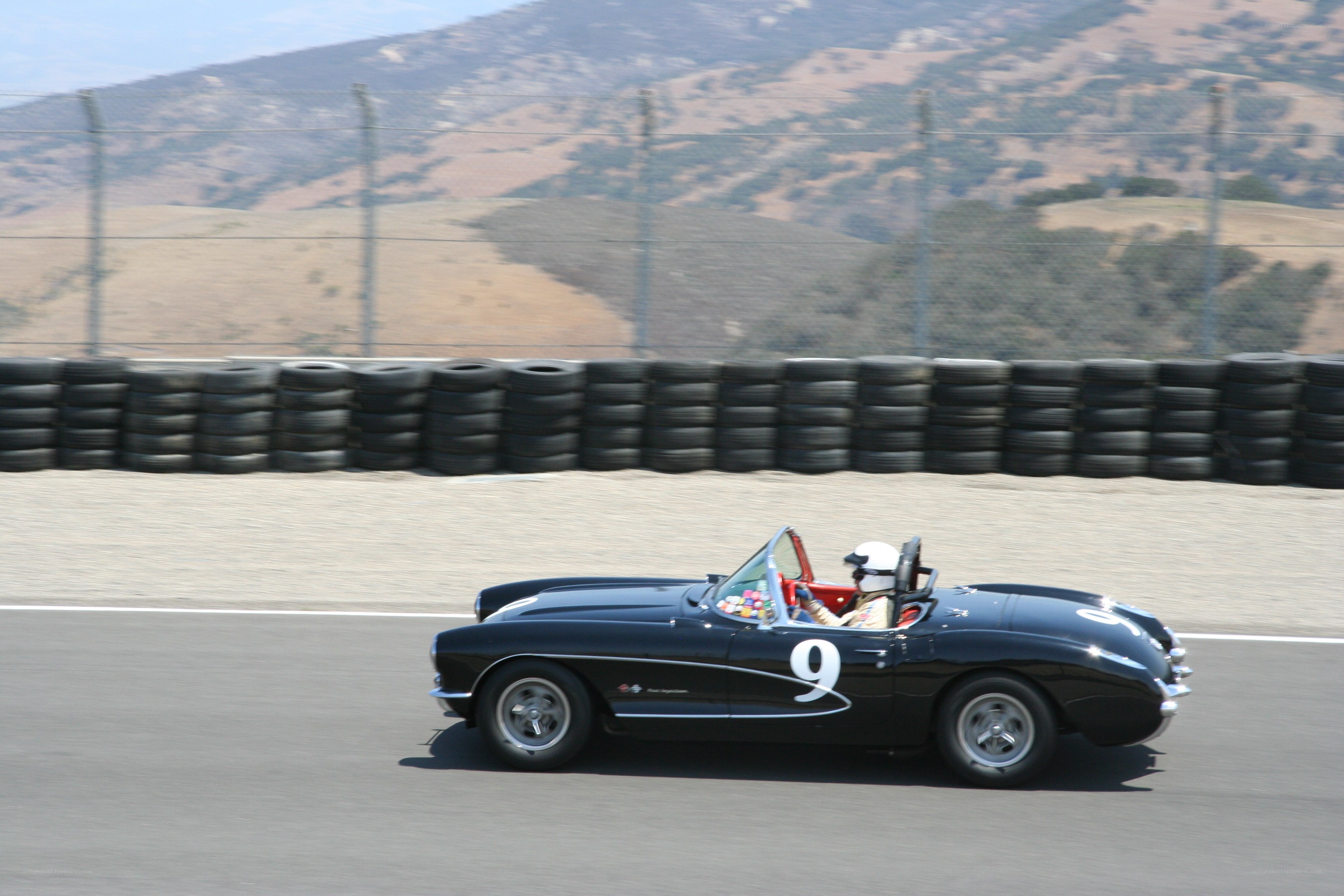 Black Corvette racing on track