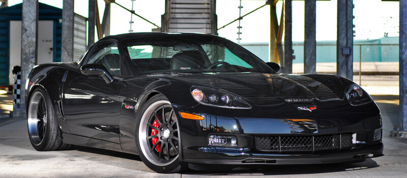Black Corvette Sports Car — Dramatic, Afternoon, Photograph, Building
