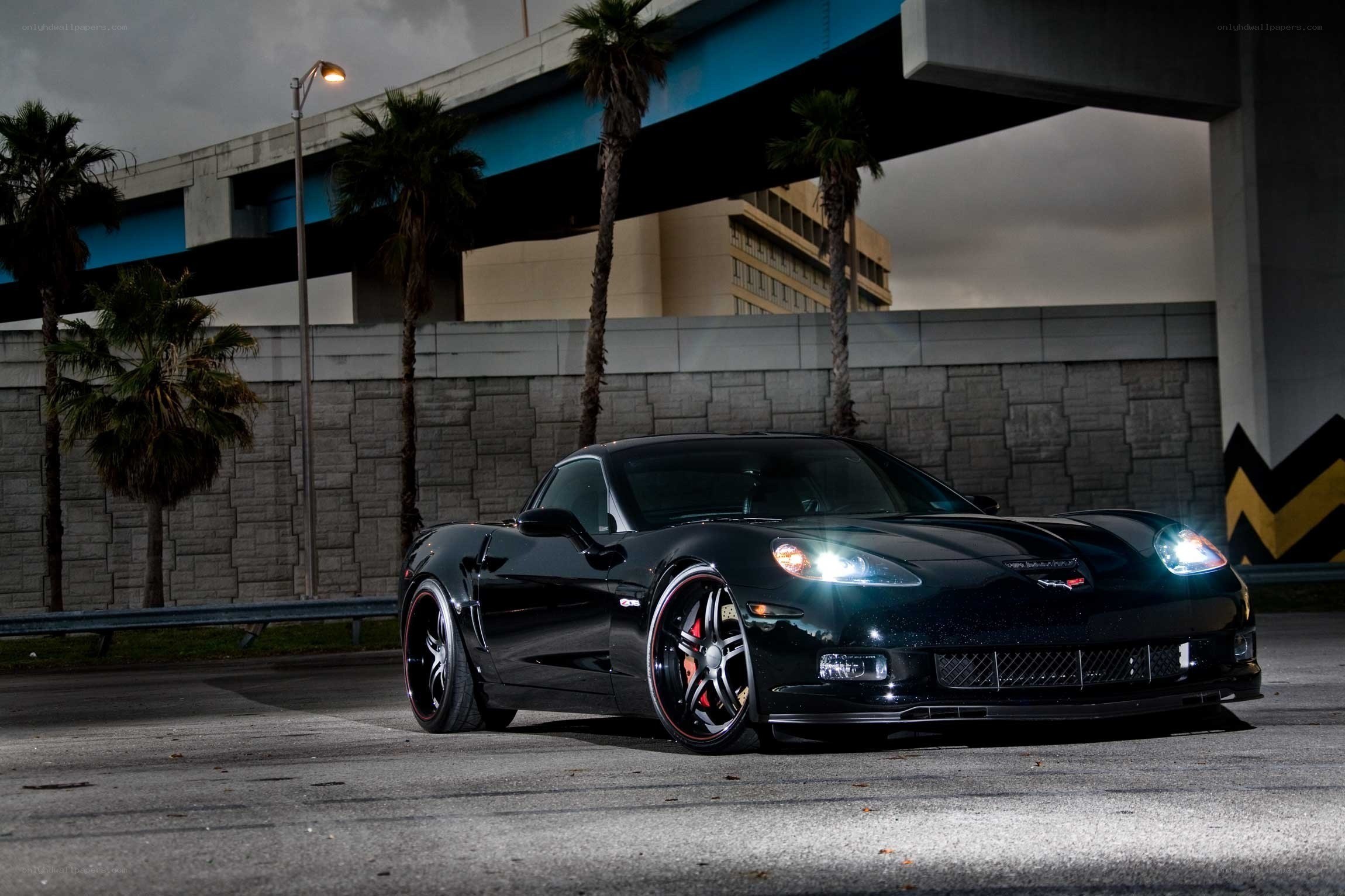 Black Corvette under an overpass