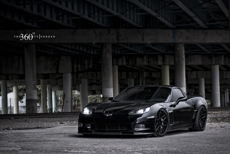Black Corvette under Bridge — Dramatic, Photograph