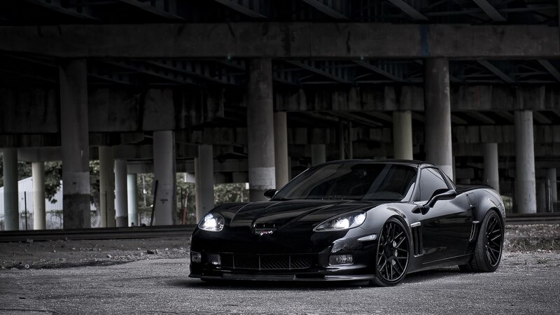 Black Corvette under overpass