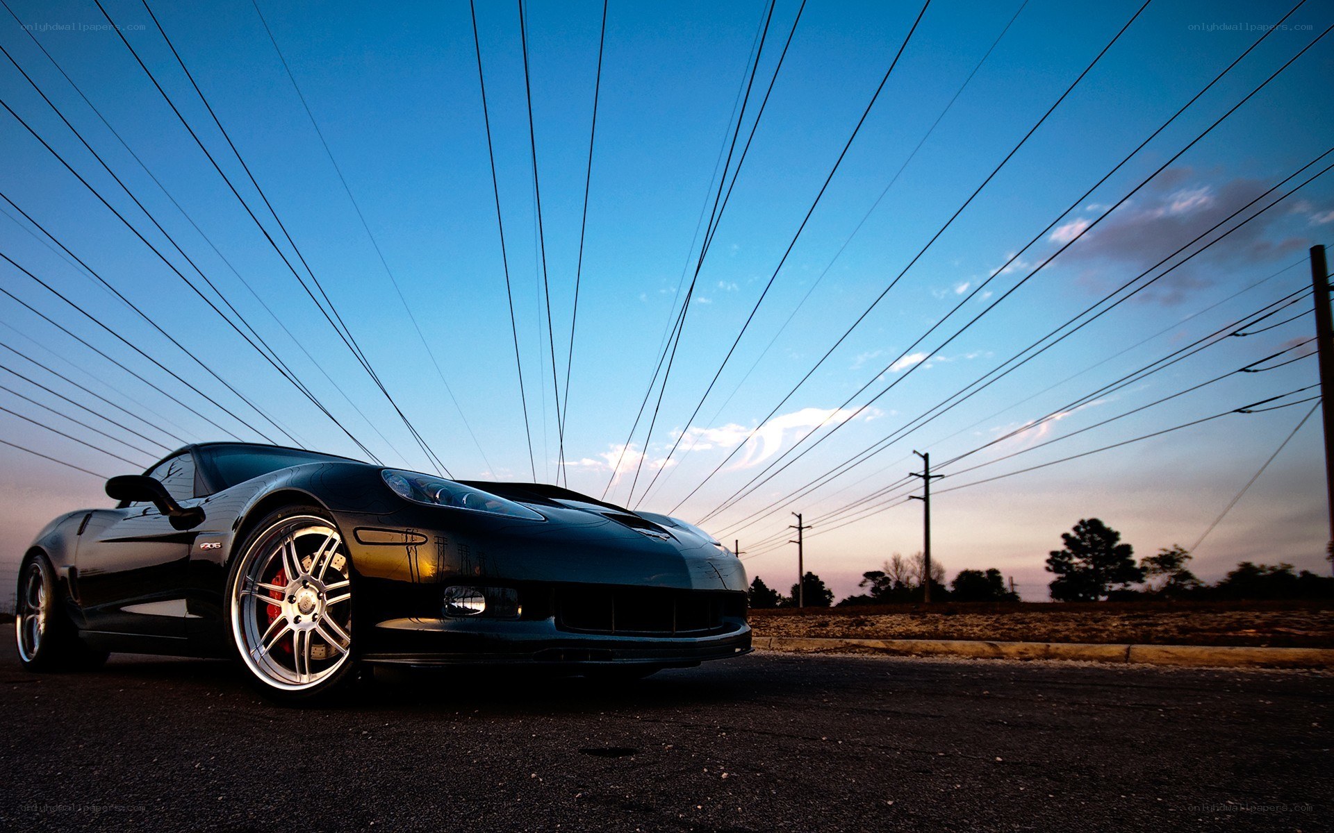 Black Corvette under power lines
