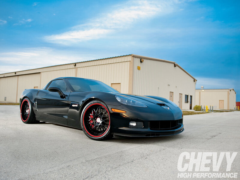 Black Corvette with red wheels