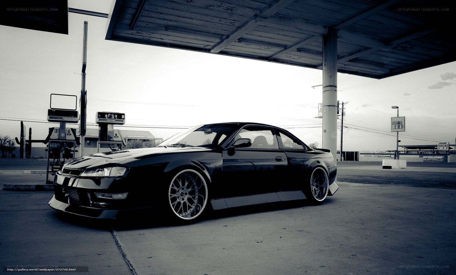 black coupe at gas station