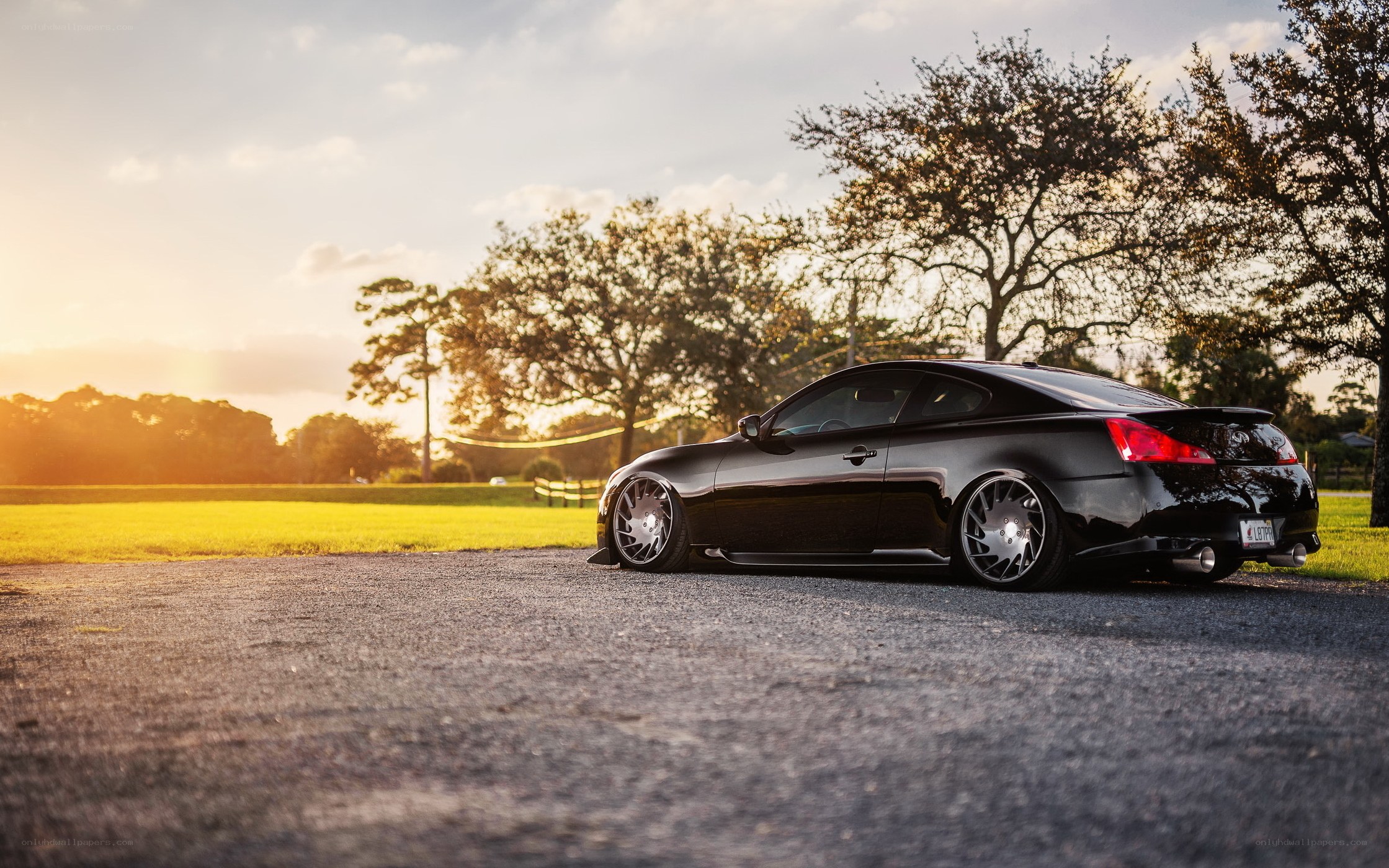 Black coupe at sunset