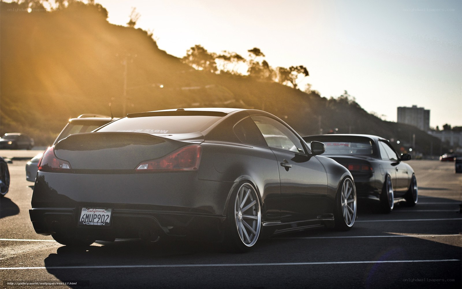 Black coupe at sunset