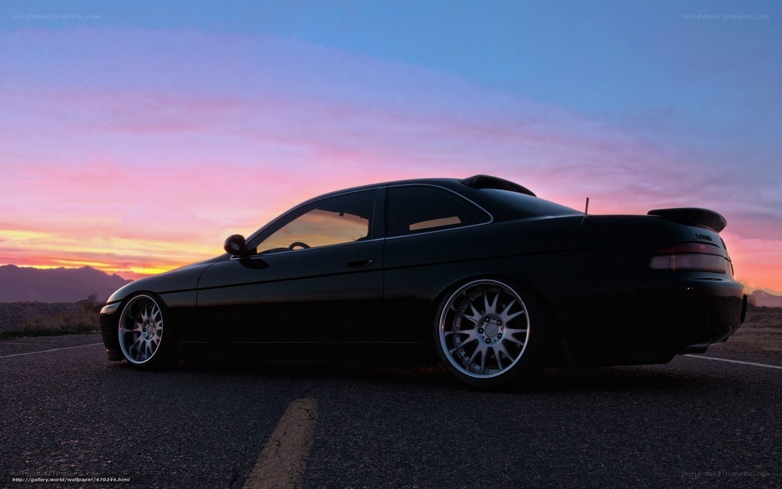 black coupe at sunset