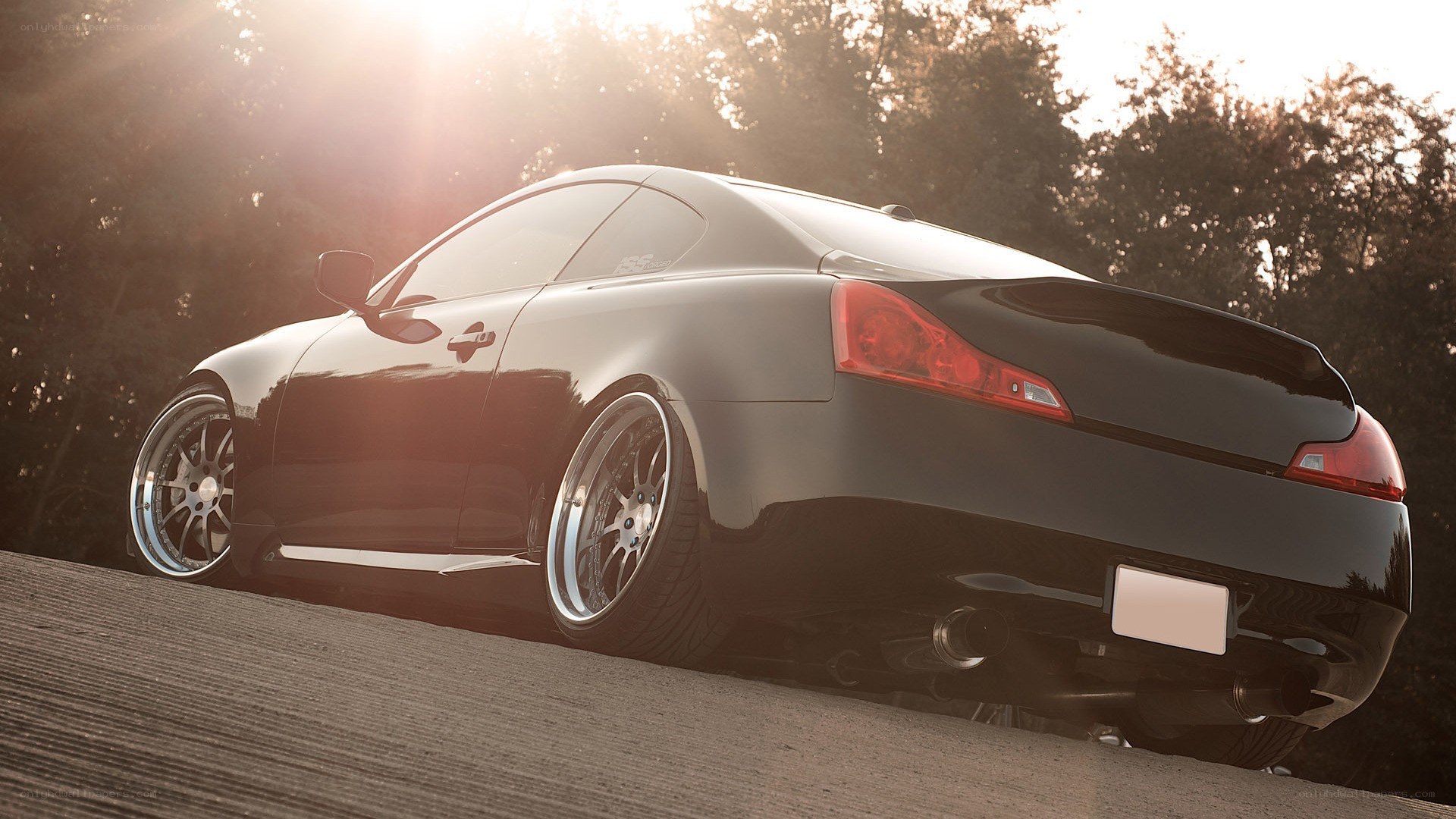 black coupe at sunset
