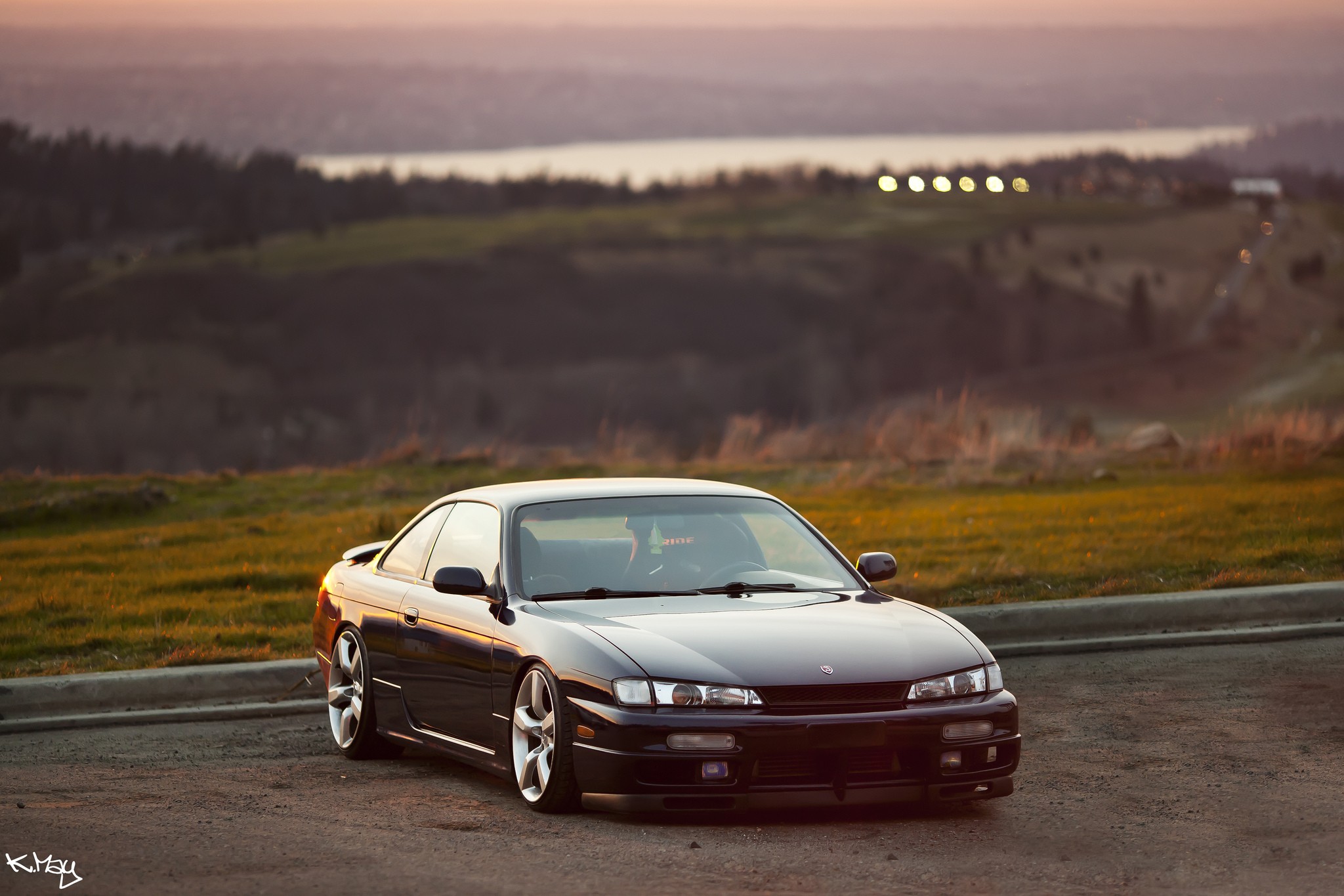 Black coupe at sunset