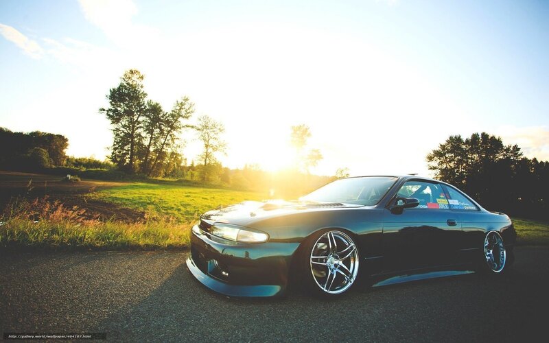 black coupe at sunset