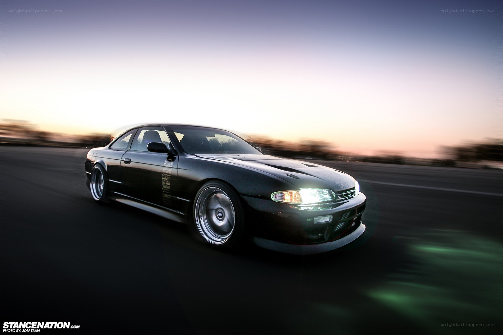 black coupe drifting at dusk