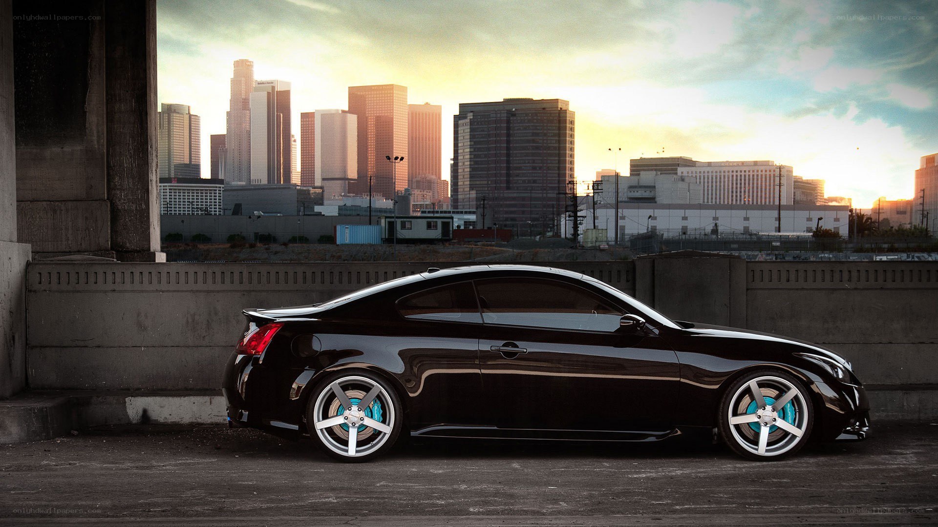 black coupe in cityscape