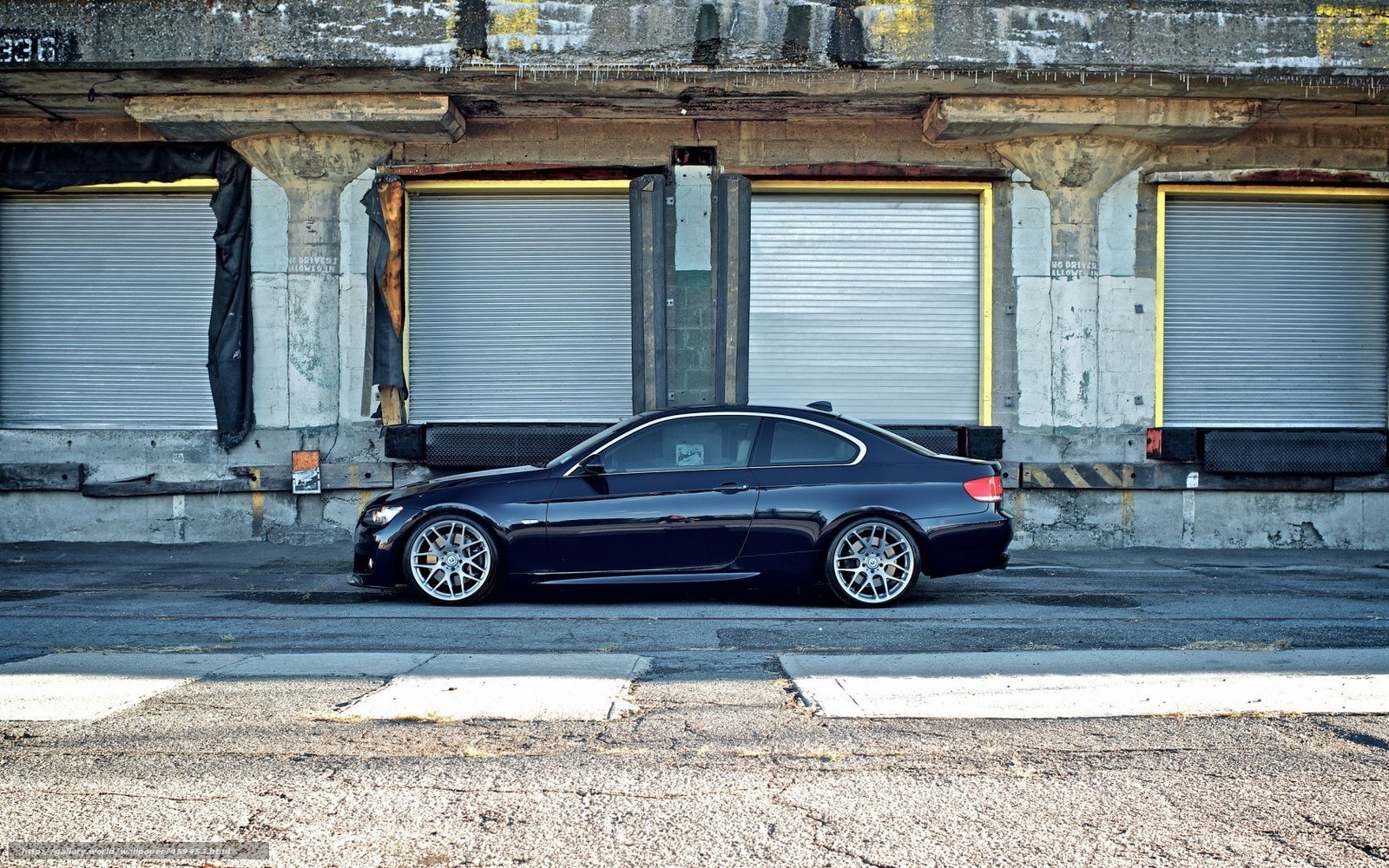 black coupe in industrial setting