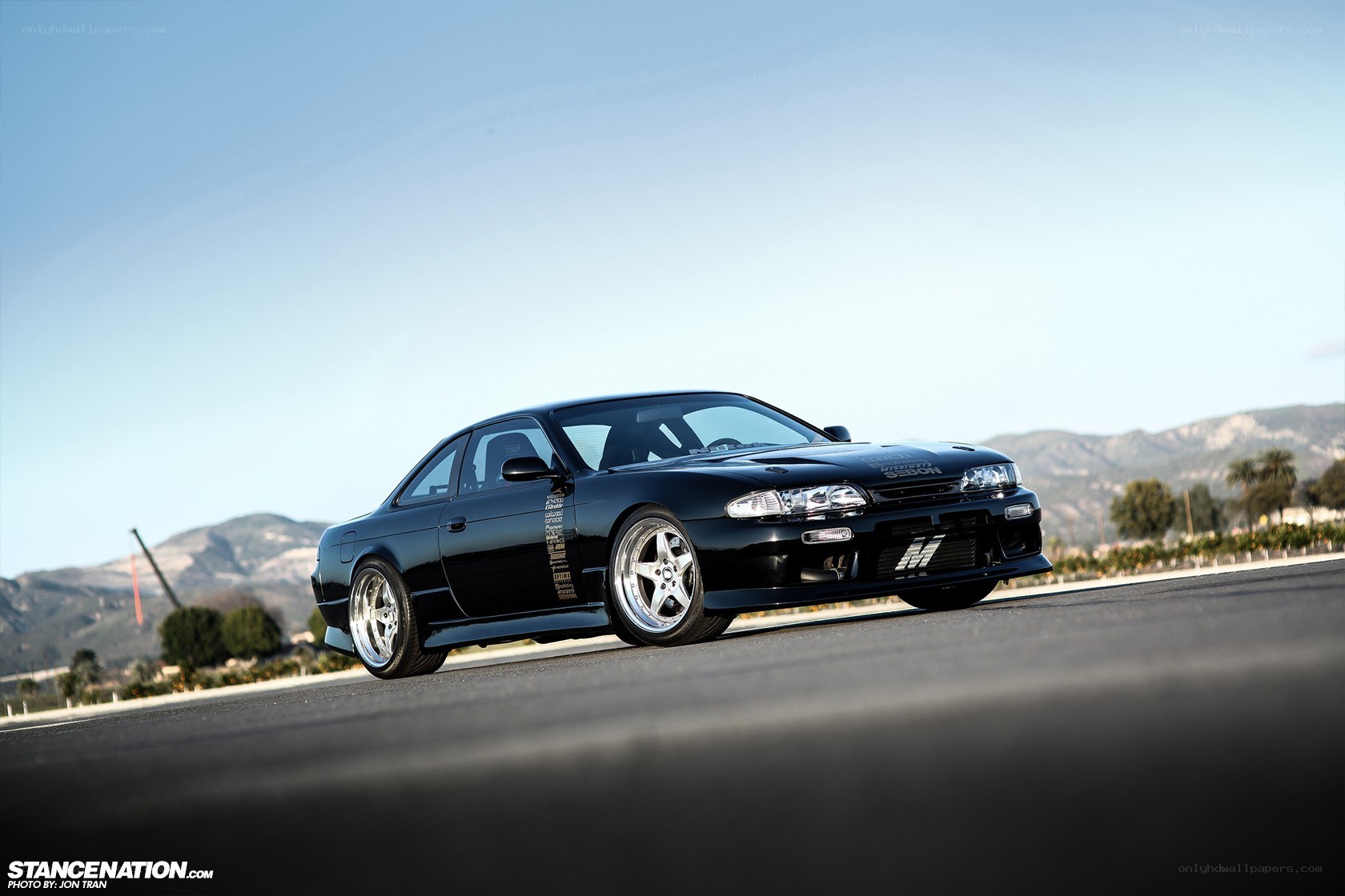 black coupe on a road