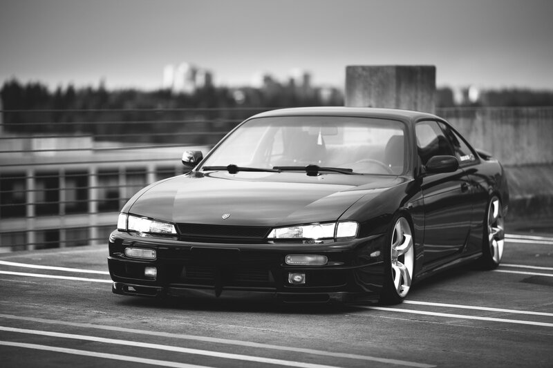 black coupe on a road