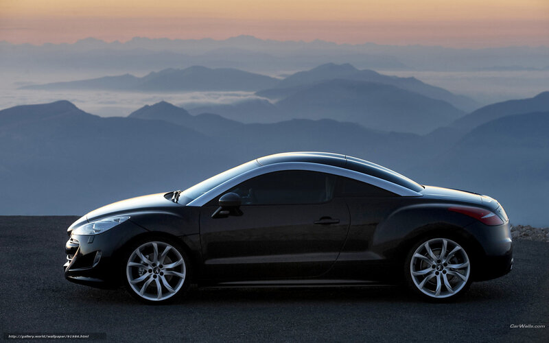 Black coupe on mountain road