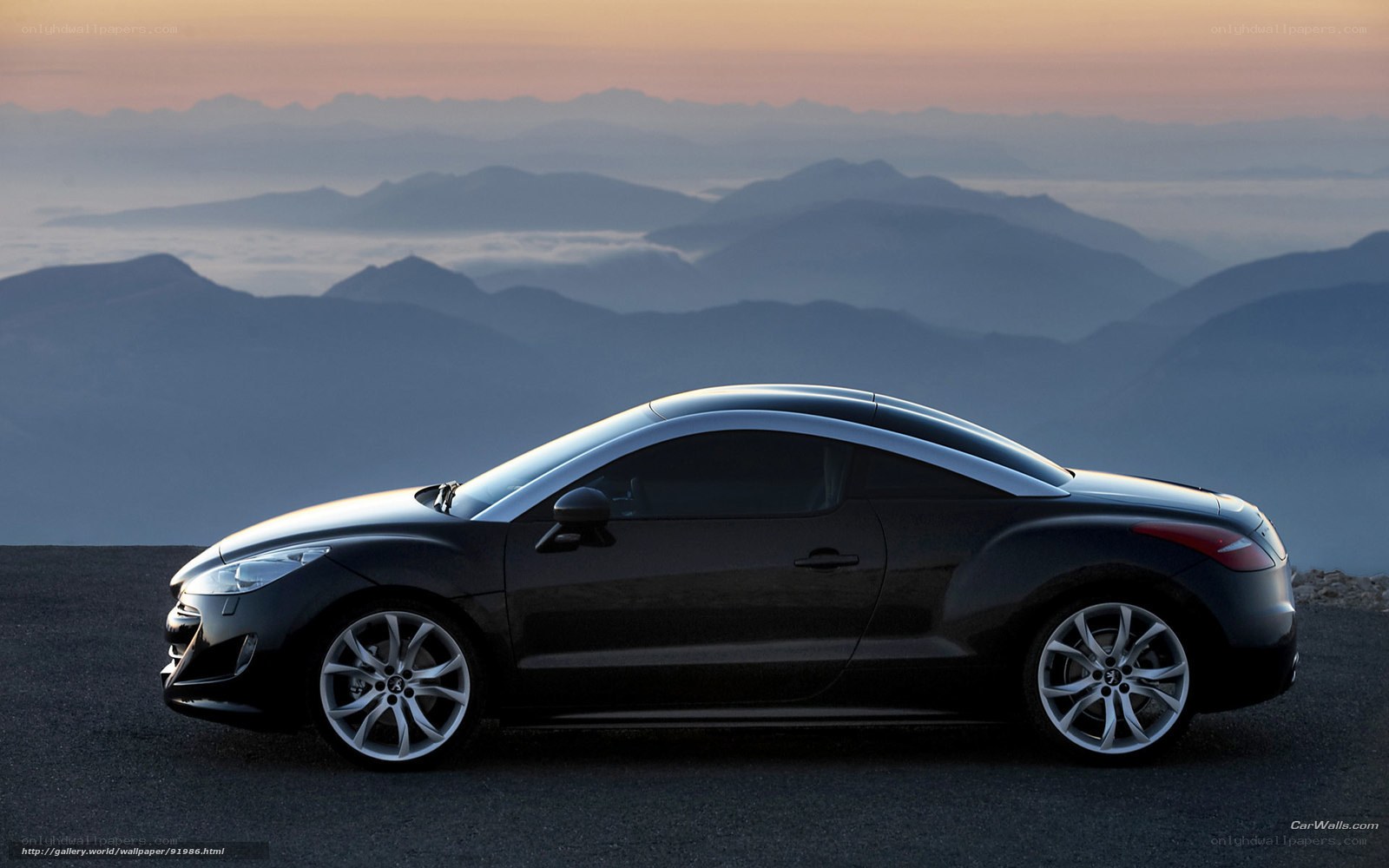 Black coupe on mountain road
